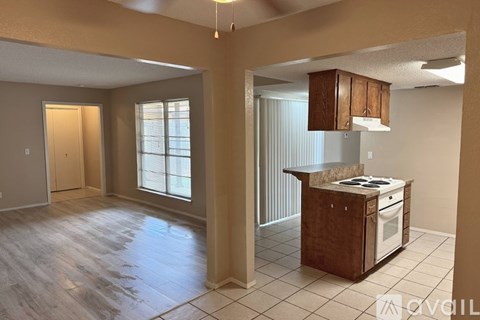 A kitchen area with a stove and cabinets.