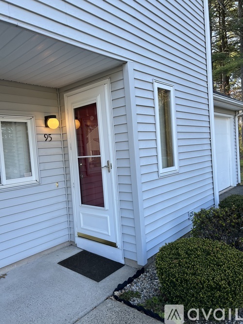 A house numbered 95 with a white door and windows.