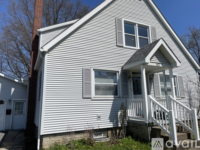A house with a white porch and a covered entry way.