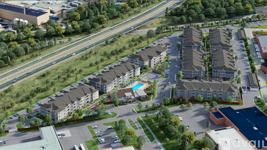 An aerial view of a large residential complex with multiple buildings and a swimming pool.