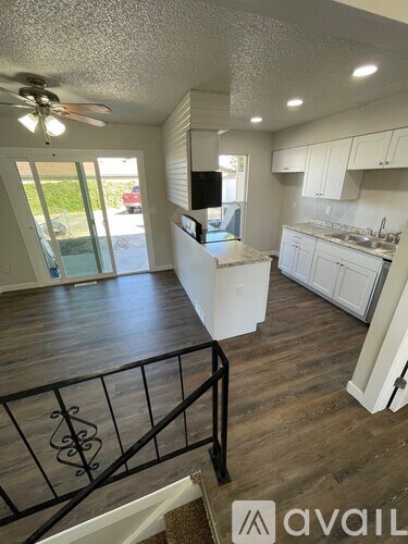 A living room with a television and sliding glass doors.