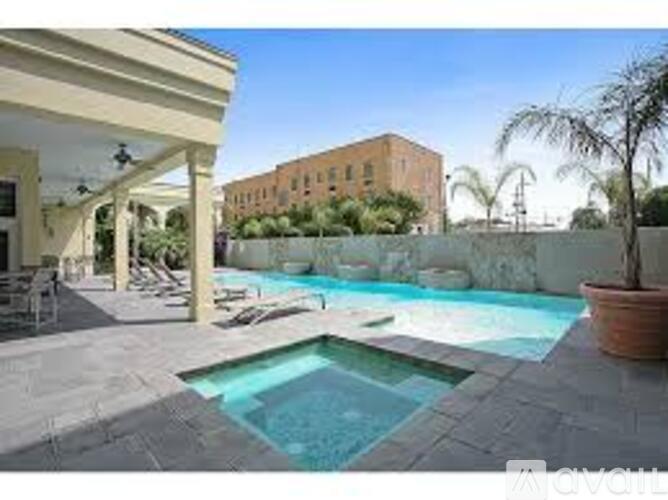 A pool with a hot tub in the middle of a patio.