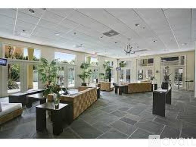 A spacious waiting area with a long bench and a coffee table.
