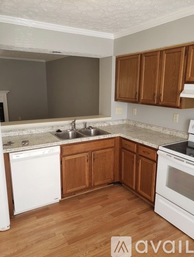 A kitchen with wooden cabinets and white appliances.