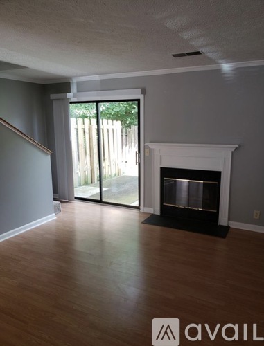 A living room with a fireplace and sliding glass doors.