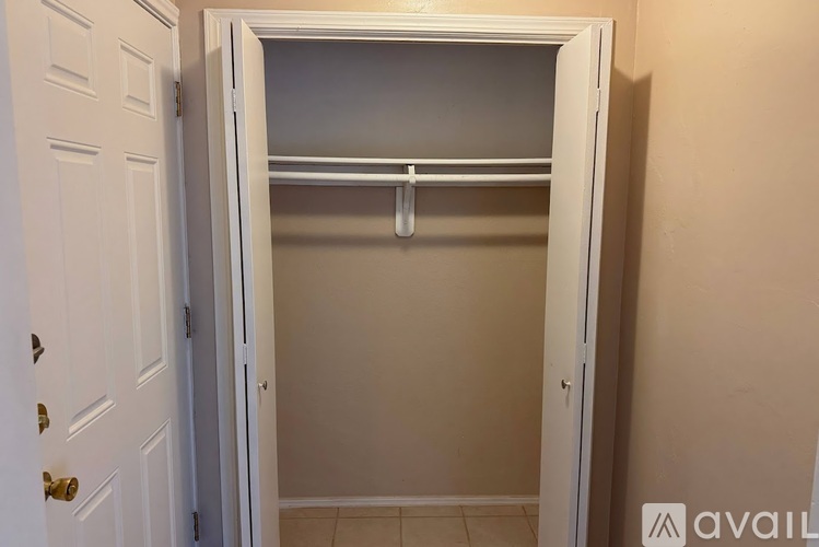 A white door with a shelf is open.