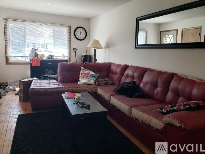A red couch with a black coffee table in front of it.