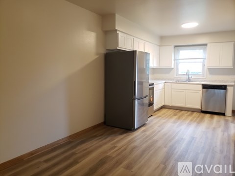 A kitchen with wooden cabinets and a white fridge.