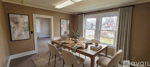 A dining room with a table set for four.