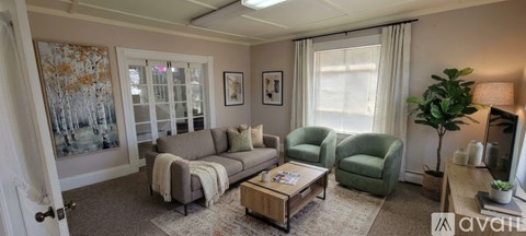 A living room with a couch, chair, and coffee table.