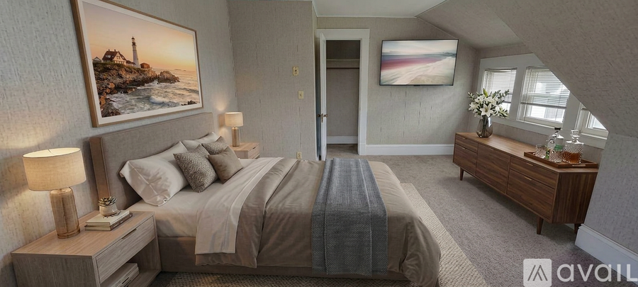 A bedroom with a large bed and a painting on the wall.