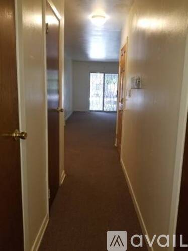 A long hallway with doors on both sides.