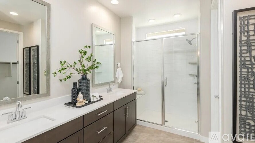 A bathroom with a white countertop and a plant on it.