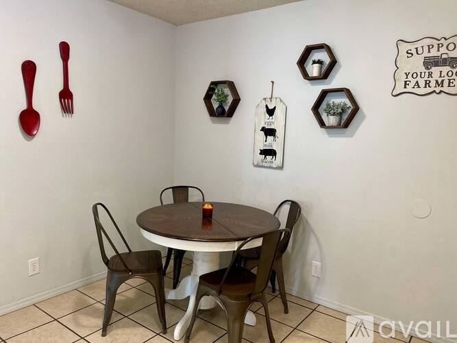A dining room with a table and chairs and a sign on the wall that says "support your local farmer".