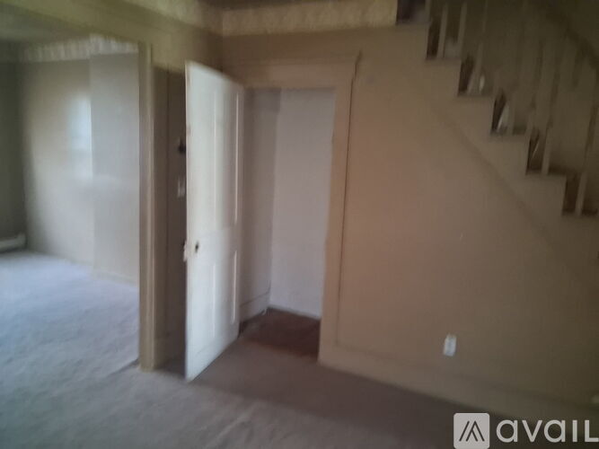 A room with a staircase and a door is available for rent.