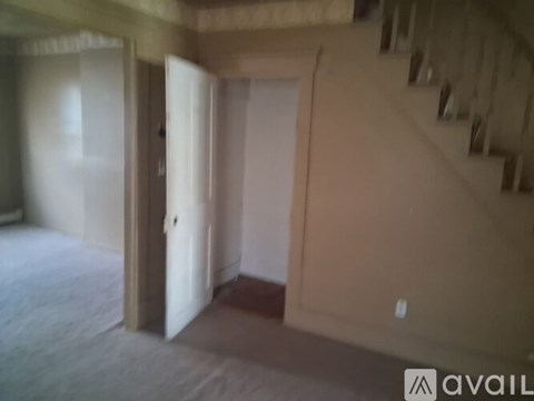 A room with a staircase and a door is available for rent.