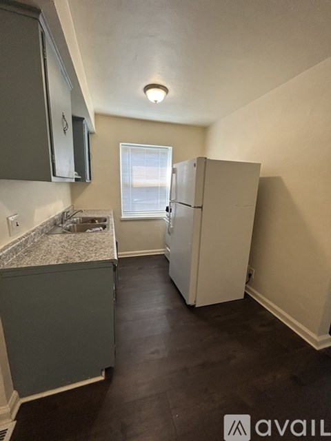 A kitchen with a refrigerator and a counter top.