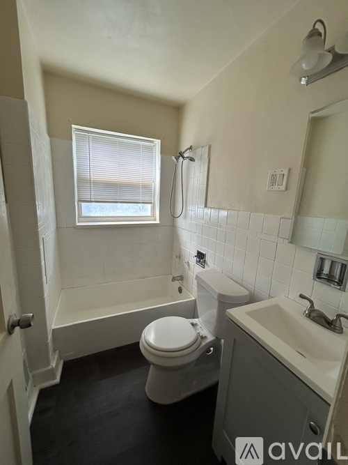 A bathroom with a toilet, sink, and bathtub.