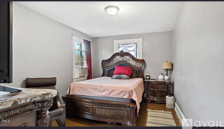 A bedroom with a large bed and a dresser.