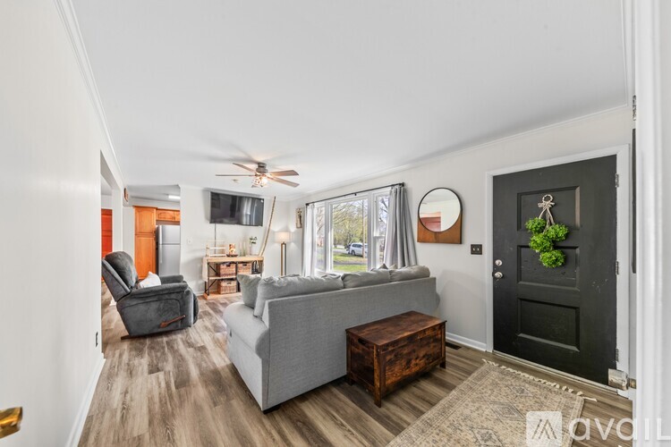 A living room with a grey couch and a wooden coffee table.