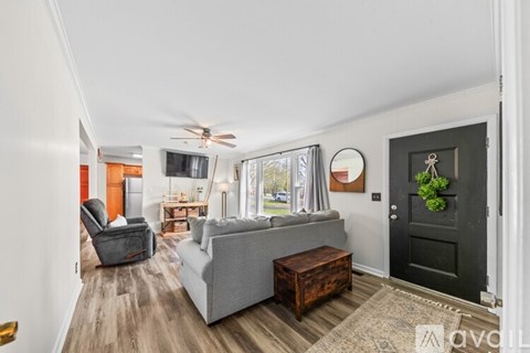 A living room with a grey couch and a wooden coffee table.