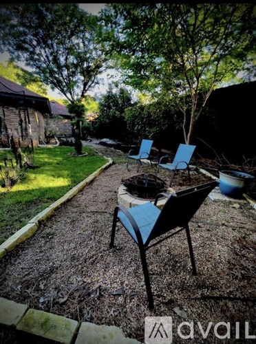 A backyard with a table and chairs.