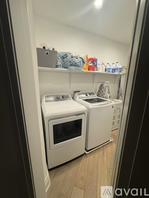 A small kitchen with two ovens and a microwave.