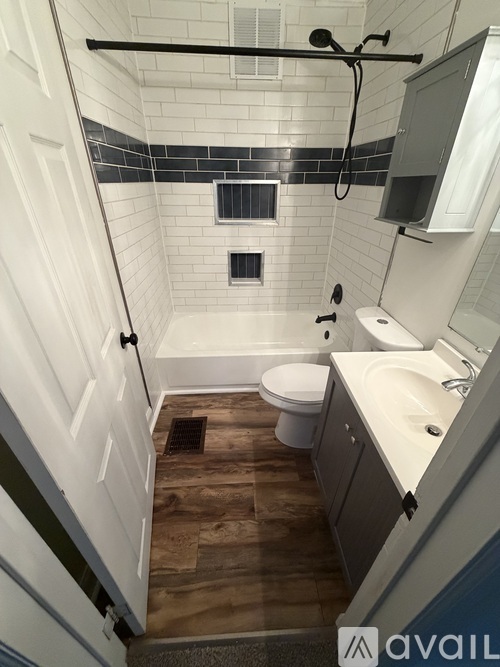 A bathroom with a toilet, sink, and shower.