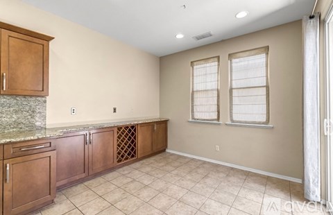 A kitchen with brown cabinets and a granite countertop.