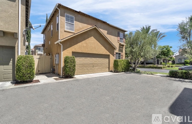 A house with a brown exterior and a driveway in front.
