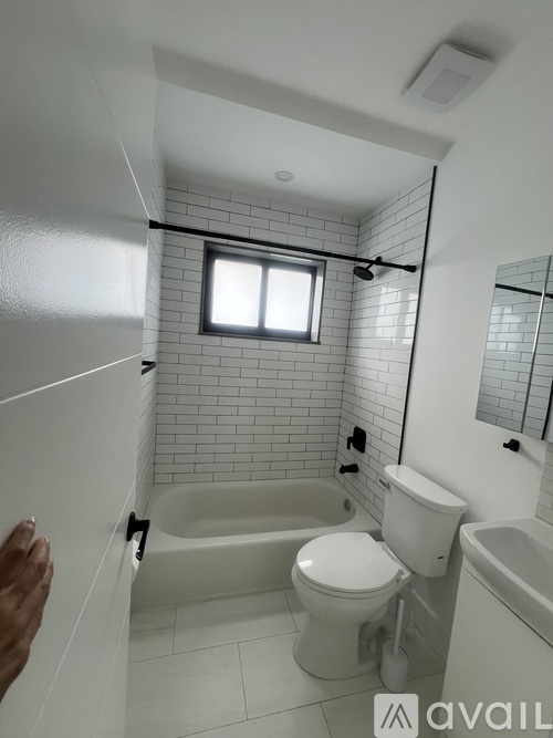 A bathroom with a toilet, tub, and sink.