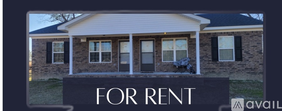 A house is for rent with a sign in front.