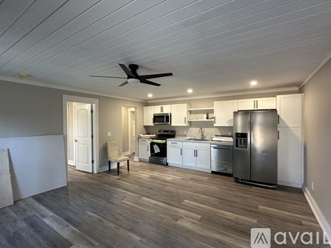 A kitchen with a refrigerator, sink, and stove is available for rent.