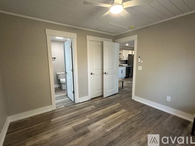 A room with a wooden floor and white walls.