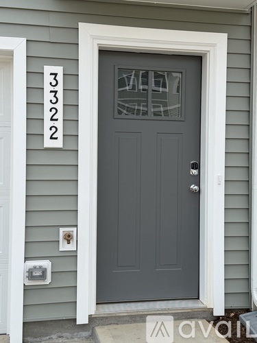 A grey door with a glass window and a number 3322 above it.