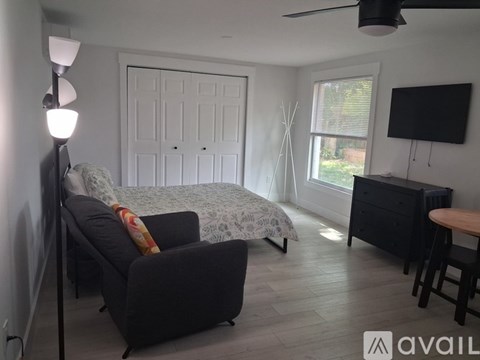 A living room with a grey couch and a white door.