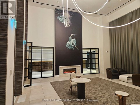 A modern living room with a fireplace and a large painting on the wall.