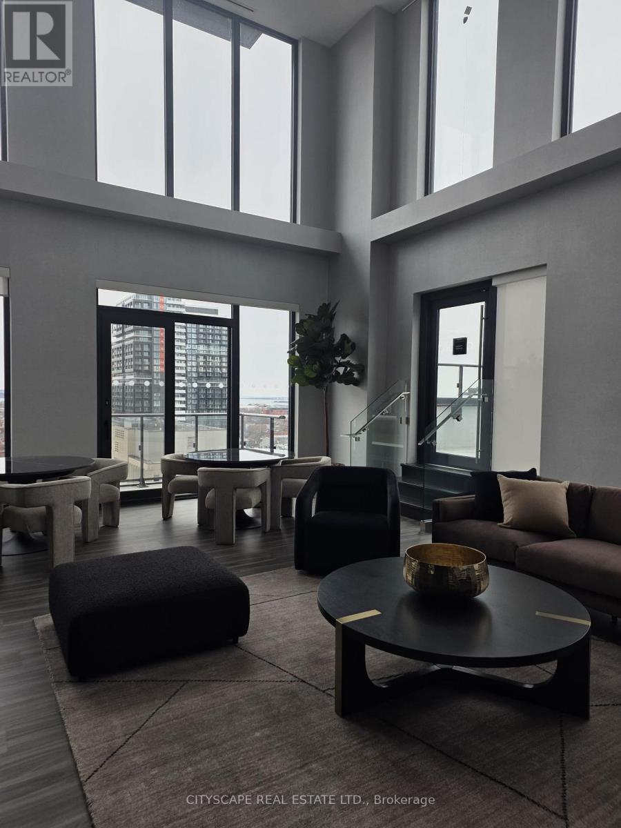 A living room with a black coffee table and a large window.