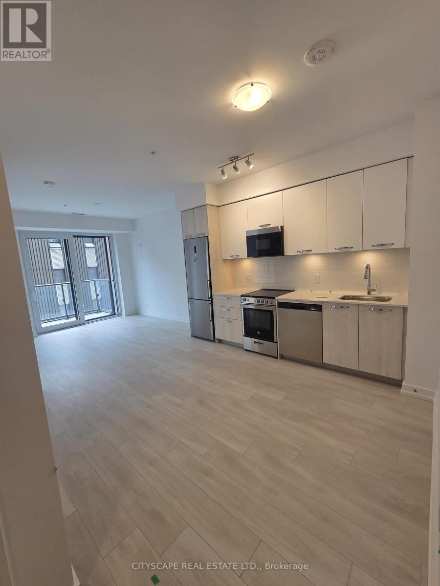 A spacious kitchen with white cabinets and stainless steel appliances.