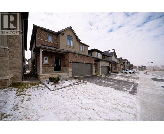 A row of houses with a realtor sign in the foreground.