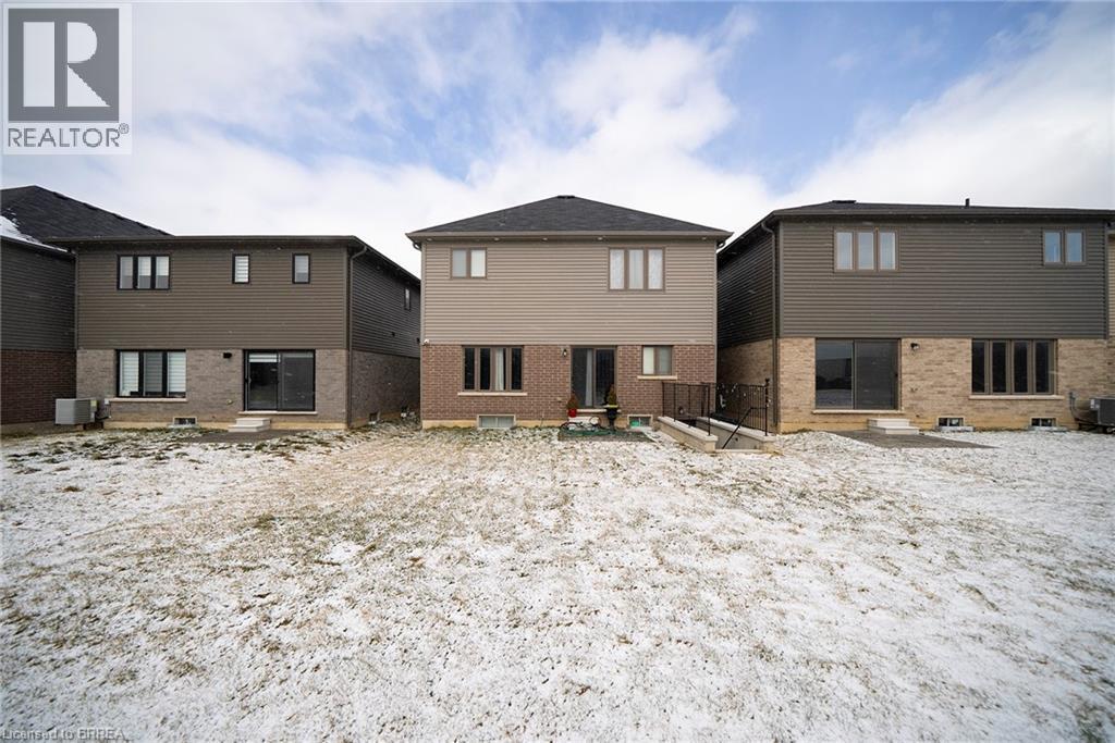 A realtor photo of a row of houses in a snowy field.