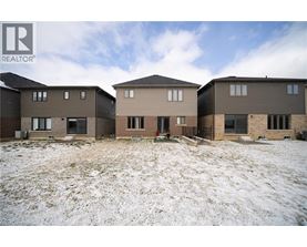 A realtor photo of a row of houses in a snowy field.