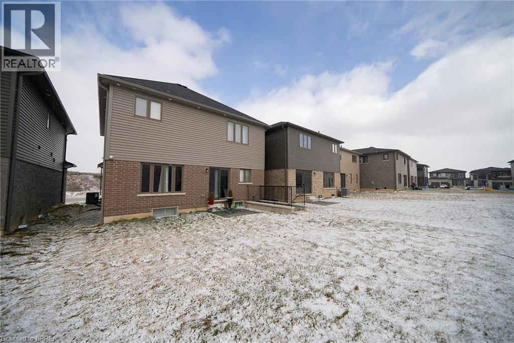 A realtor photo of a row of houses in a snowy field.