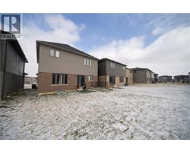 A realtor photo of a row of houses in a snowy field.