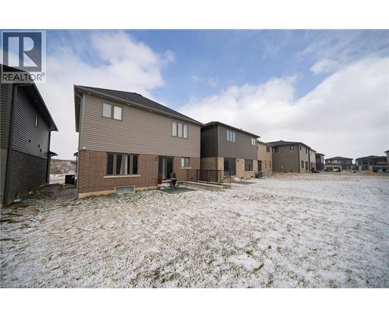 A realtor photo of a row of houses in a snowy field.
