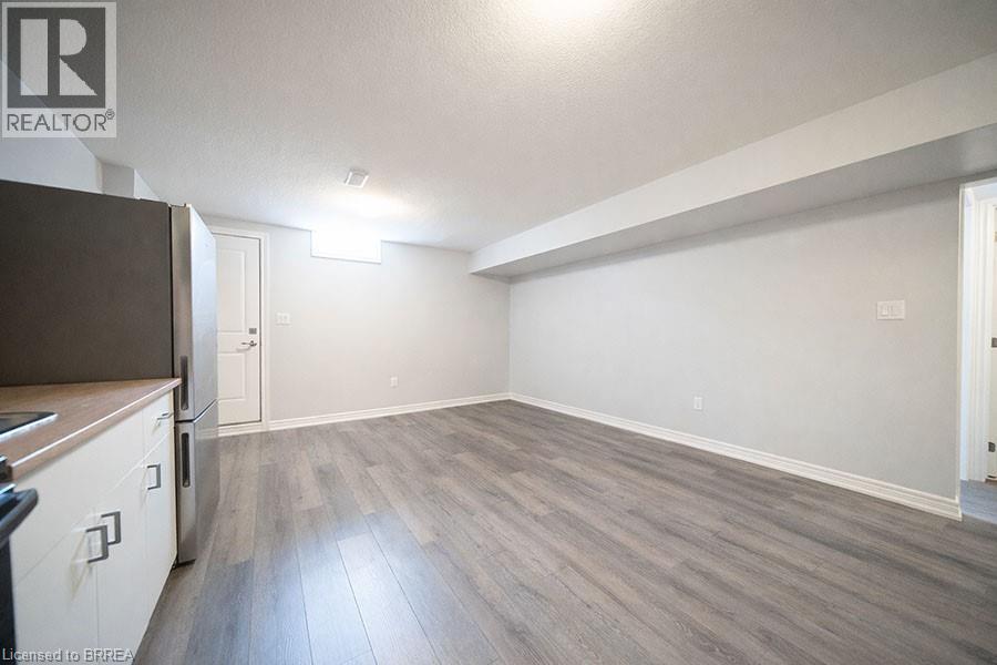 A spacious room with a grey floor and white walls.