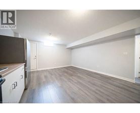 A spacious room with a grey floor and white walls.