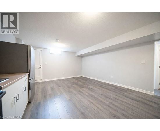 A spacious room with a grey floor and white walls.
