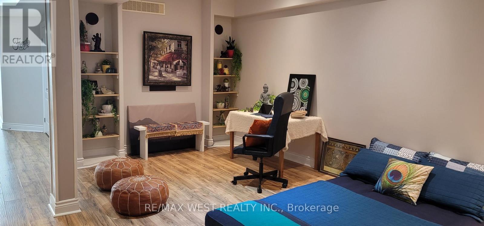 A bedroom with a bed, desk, and chair.