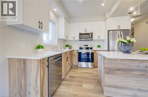 A modern kitchen with wooden cabinets and stainless steel appliances.